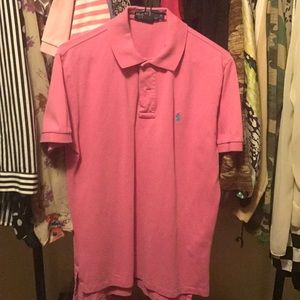 Pink polo shirt teal sign